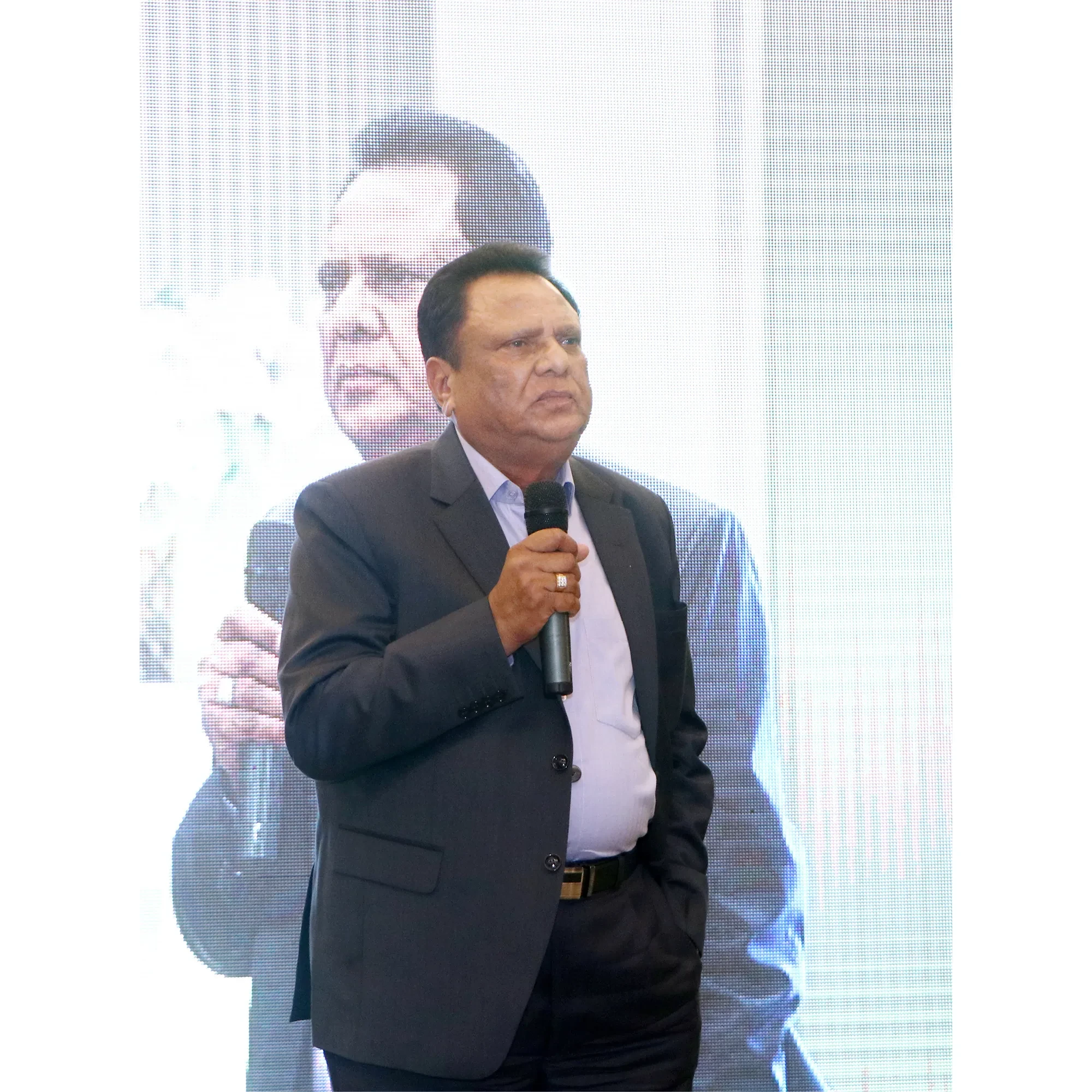 Suresh Pal addressing a gathering with a microphone